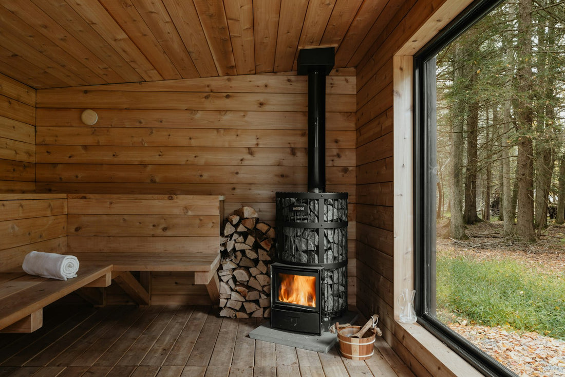 Sauna thermometer on a cedar wall above the upper bench of a hot traditional sauna